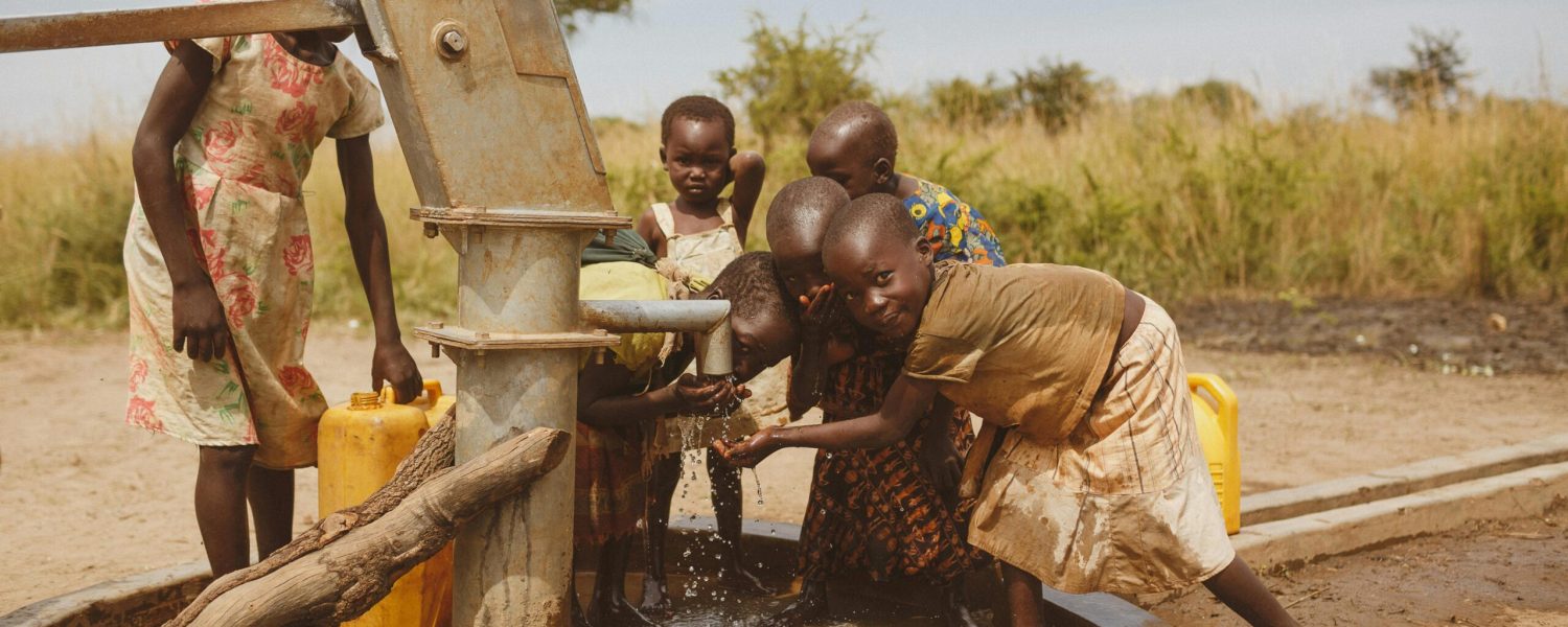 Group of children gathering water from a well in Kitgum, Uganda.